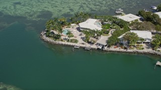 5K aerial  video of flying away from upscale home on the shore, Tavernier, Florida Aerial Stock Footage | AX0025_093