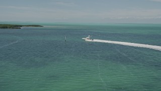 5K aerial stock footage of following a fishing boat speeding past mangroves, Tavernier, Florida Aerial Stock Footage | AX0025_095E