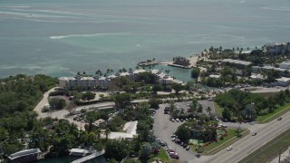 5K aerial stock footage of flying by the coastal Holiday Isle Resort and Marina, Islamorada, Florida Aerial Stock Footage | AX0025_108