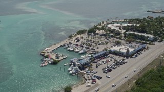 5K aerial stock footage of Whale Harbor Restaurant and Marina, Chesapeake Beach Resort, Islamorada, Florida Aerial Stock Footage | AX0025_109