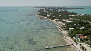 AX0025_126E - 5K aerial stock footage of flying by homes on the coast, Islamorada, Florida