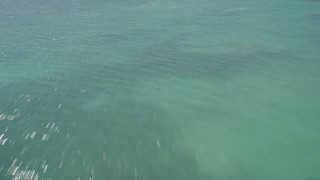 AX0025_132 - 5K aerial stock footage tilt from clear water revealing Overseas Highway bridge, Islamorada, Florida