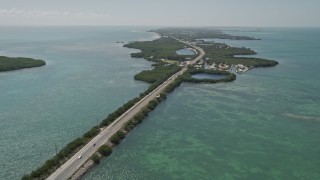 AX0025_151E - 5K aerial stock footage of flying by Overseas Highway, pan right to reveal Grassy Key, Marathon, Florida