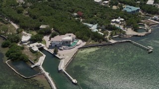 5K aerial stock footage of flying by a large home on shore of Grassy Key, Marathon, Florida Aerial Stock Footage | AX0025_156