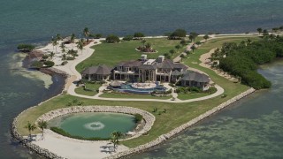 AX0025_158E - 5K aerial stock footage of orbiting mansion on Long Point Key, Marathon, Florida