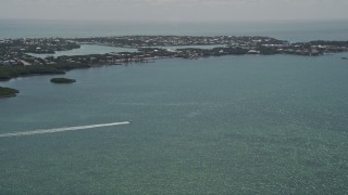 5K aerial stock footage of tracking speed boat off the shore, Fat Deer Key, Marathon, Florida Aerial Stock Footage | AX0025_162