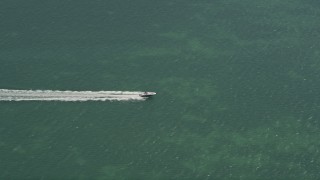 AX0025_163 - 5K aerial stock footage of tracking speedboat off shore of Fat Deer Key, Marathon, Florida