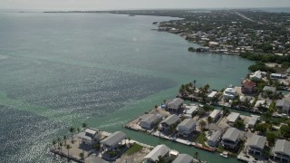 5K aerial stock footage flying over the Atlantic Ocean near homes on the coast, Marathon, Florida Aerial Stock Footage | AX0026_004