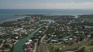 5K aerial stock footage of flying by homes and canals along coast, Marathon, Florida Aerial Stock Footage | AX0026_009