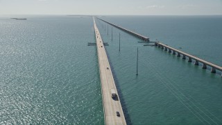 AX0026_023 - 5K aerial stock footage fly over Atlantic Ocean, reveal light traffic on Seven Mile Bridge, Florida