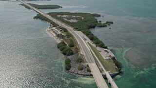 AX0026_032 - 5K aerial stock footage of flying by light traffic, revealing several Keys, Seven Mile Bridge, Florida