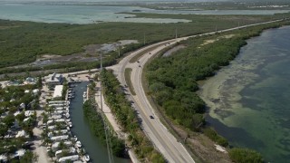 5K aerial stock footage of following Overseas Highway past Big Pine Key Fishing Lodge, Big Pine Key, Florida Aerial Stock Footage | AX0026_045E