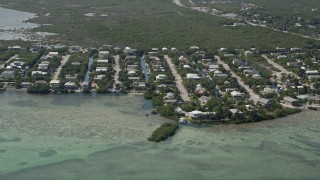 AX0026_053 - 5K aerial stock footage video of approaching homes and canals, Ramrod Key, Florida