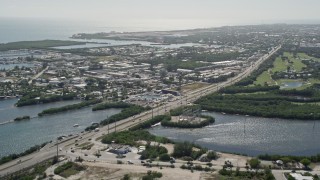 AX0026_057E - 5K aerial stock footage of flying by boats, Stock Island, revealing Key West Golf Club, Key West, Florida