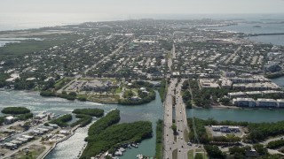 5K aerial stock footage of following Overseas Highway, approaching the shore of Key West, Florida Aerial Stock Footage | AX0026_059