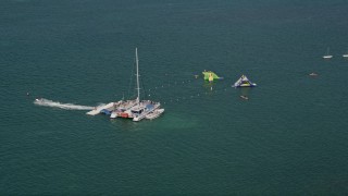 5K aerial stock footage of flying over swimmers, floats, off the shore of Key West, Florida Aerial Stock Footage | AX0026_086E