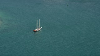 5K aerial stock footage of tracking a sailboat on the open water by Key West, Florida Aerial Stock Footage | AX0026_094