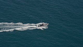 5K aerial stock footage of a boat racing across the water near the shore of Key West, Florida Aerial Stock Footage | AX0026_108