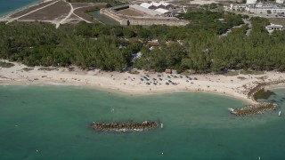 AX0026_110 - 5K aerial stock footage of sunbathers by Fort Zachary Taylor Historic State Park, Key West, Florida