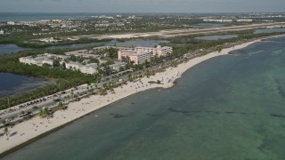 AX0026_118 - 5K aerial stock footage of sunbathers on Smathers Beach, Sheraton Suites Key West in Key West, Florida