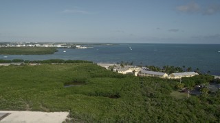 AX0027_001E - 5K aerial stock footage lift off from Key West International Airport, reveal resort, Key West, Florida