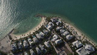 5K aerial stock footage of flying by homes along the beach, Sunset Key, Key West, Florida Aerial Stock Footage | AX0027_017