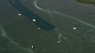 5K aerial stock footage of flying over catamarans and jet skiers near dredge, Sigsbee Park, Key West, Florida Aerial Stock Footage | AX0027_027