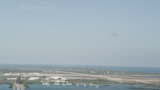 5K aerial stock footage of tracking four F-18s in flight above Naval Air Station Key West, Key West, Florida Aerial Stock Footage | AX0027_033