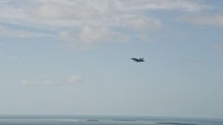 AX0027_035 - 5K aerial stock footage of tracking an F-18 in flight, Naval Air Station Key West, Key West, Florida