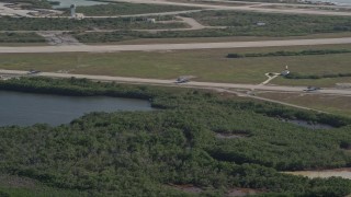 5K aerial stock footage of tracking F-18s taxiing on the runway, Naval Air Station Key West, Key West, Florida Aerial Stock Footage | AX0027_040