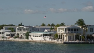 AX0027_065 - 5K aerial stock footage of flying by homes on the shore, Cudjoe Key, Florida