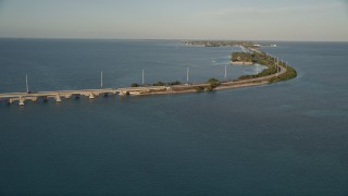 5K aerial stock footage of flying over Atlantic Ocean, revealing Overseas Highway at sunset, Craig Key, Florida Aerial Stock Footage | AX0028_020