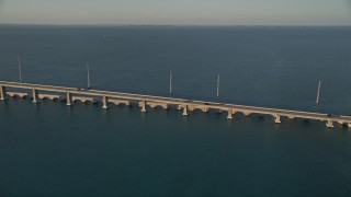 5K aerial stock footage of tracking light traffic on Overseas Highway bridge at sunset, Craig Key, Florida Aerial Stock Footage | AX0028_021