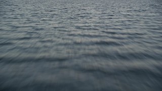 AX0028_030 - 5K aerial stock footage of flying low over the ocean at sunset in Islamorada, Florida