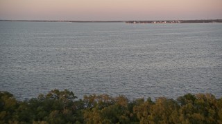 5K aerial stock footage of flying over mangroves and a bay at sunset, Key Largo, Florida Aerial Stock Footage | AX0028_041