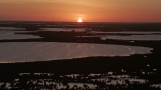 5K aerial stock footage of descending toward the water and mangrove islands, Key Largo, Florida, sunset Aerial Stock Footage | AX0028_045E