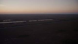 AX0028_059 - 5K aerial stock footage of flying by South Dixie Highway, Homestead, Florida, twilight