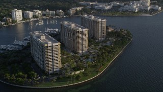 AX0029_008 - 5K aerial stock footage flyby condominium complexes on Grove Isle, Florida, sunrise