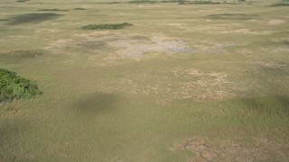 AX0030_033E - 5K aerial stock footage of flying over cloud shadows on marshland, Florida Everglades, Florida