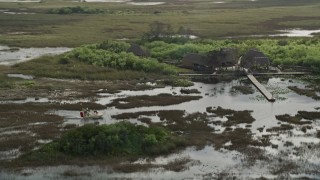 5K aerial stock footage of tracking a fanboat near dock, Florida Everglades, Florida Aerial Stock Footage | AX0030_066