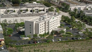 AX0031_001 - 5K aerial stock footage of approaching Holiday Inn Express Hotel and Suites, Kendall, Florida