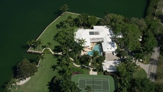 5K aerial stock footage of flying over a mansion by the water, Coral Gables, Florida Aerial Stock Footage | AX0031_007