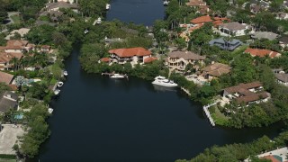 5K aerial stock footage of flying by mansions near canal, Coral Gables, Florida Aerial Stock Footage | AX0031_008