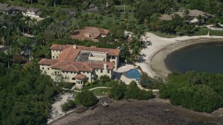 5K aerial stock footage of flying by a mansion by a canal, Coral Gables, Florida Aerial Stock Footage | AX0031_012