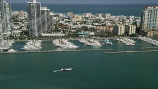 5K aerial stock footage of flying by yachts docked at Miami Beach Marina, South Beach, Florida Aerial Stock Footage | AX0031_047