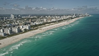 5K aerial stock footage of flying by the beach South Beach, Miami Beach, Florida Aerial Stock Footage | AX0031_051