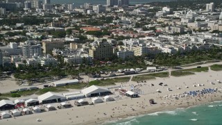 5K aerial stock footage of flying by sunbathers on the beach, South Beach, Miami Beach, Florida Aerial Stock Footage | AX0031_053