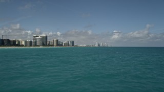 5K aerial stock footage of flying low over Atlantic Ocean near Bal Harbour, Sunny Isles Beach, Florida Aerial Stock Footage | AX0031_069