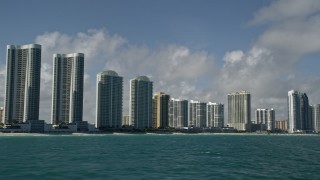 5K aerial stock footage fly by Trump Towers, condominium complexes, Sunny Isles Beach, Florida Aerial Stock Footage | AX0031_075E