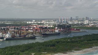 AX0031_099 - 5K aerial stock footage of flying by cargo ships at Port Everglades; Fort Lauderdale, Florida